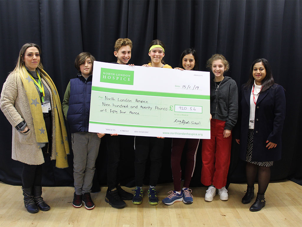 students holding a big cheque