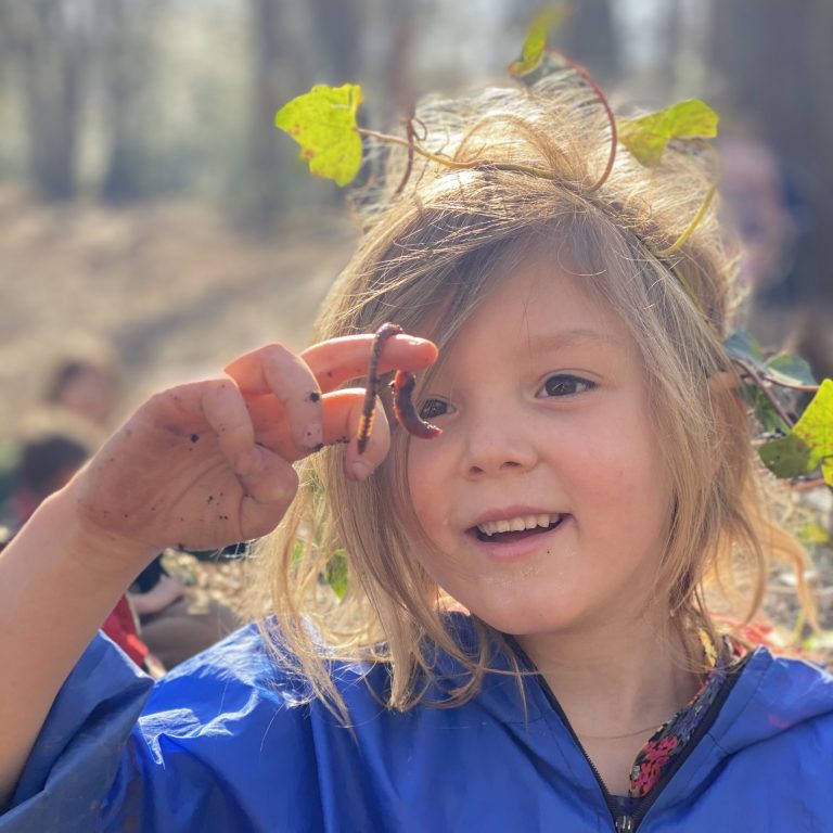 Forest school - student holding a worm
