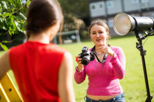 A Sixth Form student directs another student as part of an A level photography project