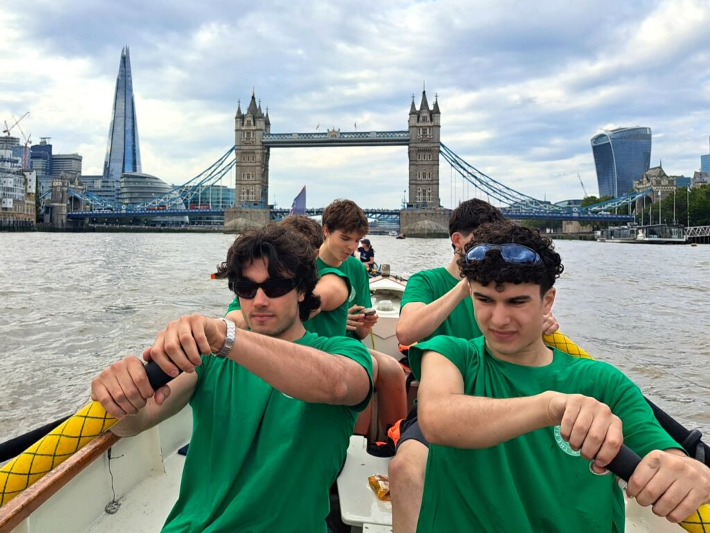 Five students from The King Alfred School Sixth Form pictured inside a rowing boat, with London Bridge and the Shard in the background