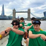 Five students from The King Alfred School Sixth Form pictured inside a rowing boat, with London Bridge and the Shard in the background