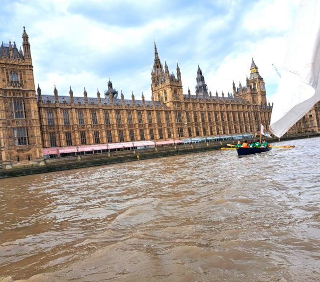 The Houses of Parliament pictured from the River Thames, with a boat from The King Alfred School in the foreground