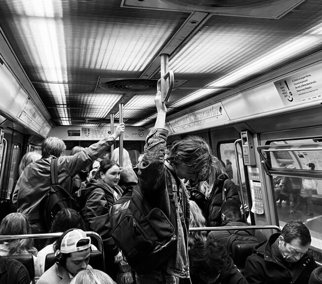 Black and white shot of students from The King Alfred School riding the Metro in Pairs