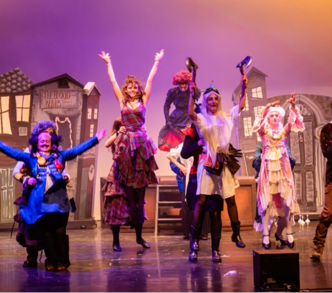 The cast of The Ballad of Raggedy Alice dance on stage