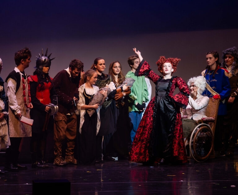 The cast of The Ballad of Raggedy Alice sing and dance on stage