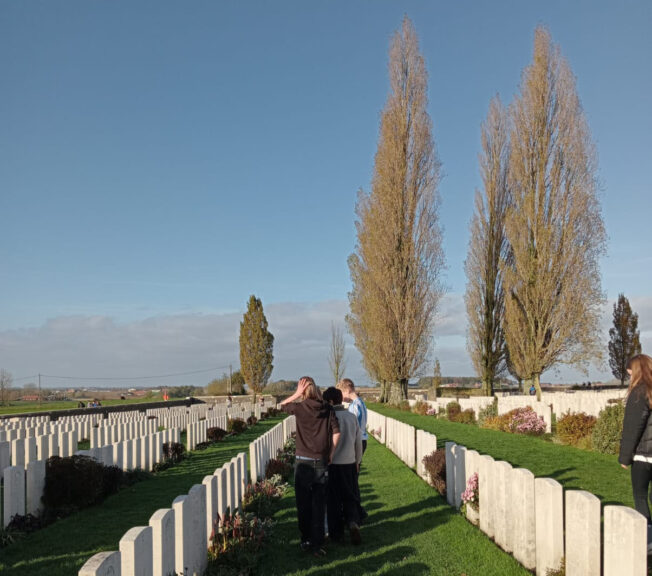 Students looking at the grave markers in Tyne Cot Cemetery