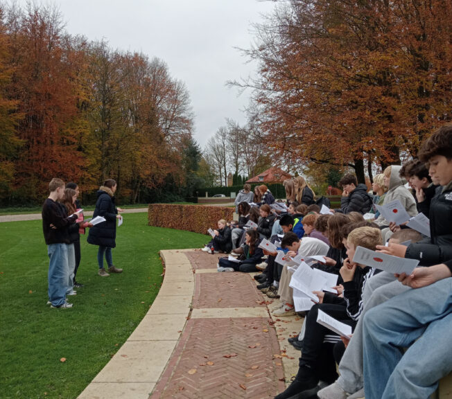 Students listening to WW1 poetry at a battlefield memorial