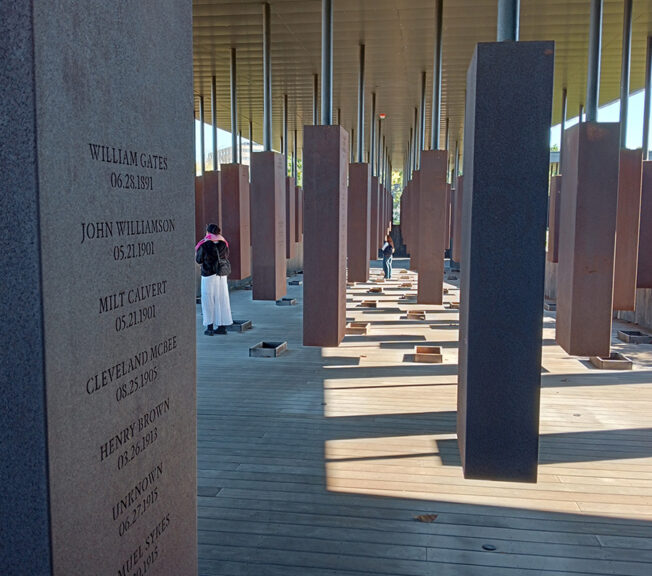 Students examine hanging steel boxes engraved with the names of lynching victims at the The National Memorial for Peace and Justice in Montgomery, Alabama