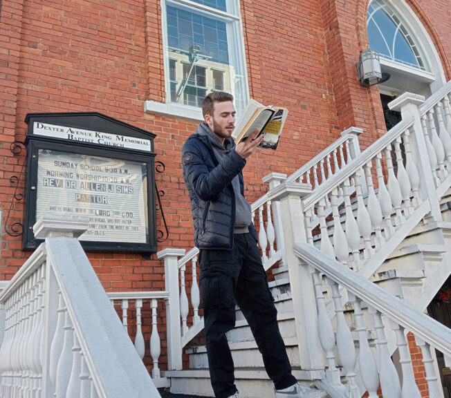 A male student from The King Alfred School reads Martin Luther King's 'I Have a Dream' speech on the steps of the Dexter Avenue King Memorial Baptist Church