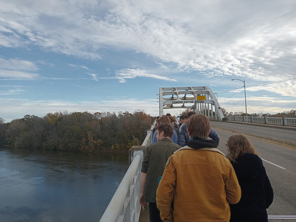 Students cross the Edmund Pettus Bridge, with the Alabama River to their left