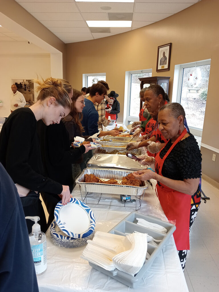 Students are served fried chicken, green beans, rice and Pasta Alfredo by members of congregation at the Mount Zion African Baptist Church