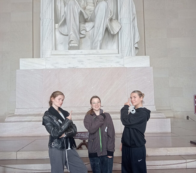 Students from The King Alfred School pose in front of the white marble statue of Abraham Lincoln at the Lincoln Memorial in Washington DC