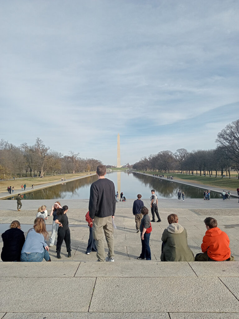 Students from The King Alfred School sit on the steps of the Lincoln Memorial in Washington DC, with the Washington Monument in the background