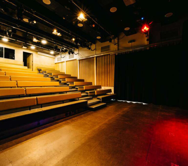 The King Alfred Phoenix Theatre with bench style seating in place and the stage lit up