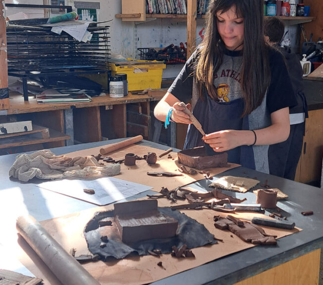 Students in the art room creating clay moulds at The King Alfred School North London