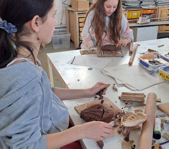 Students in the art room creating clay moulds at The King Alfred School North London