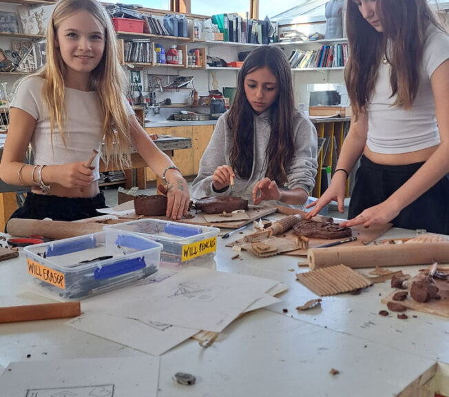 Students in the art room creating clay moulds at The King Alfred School North London