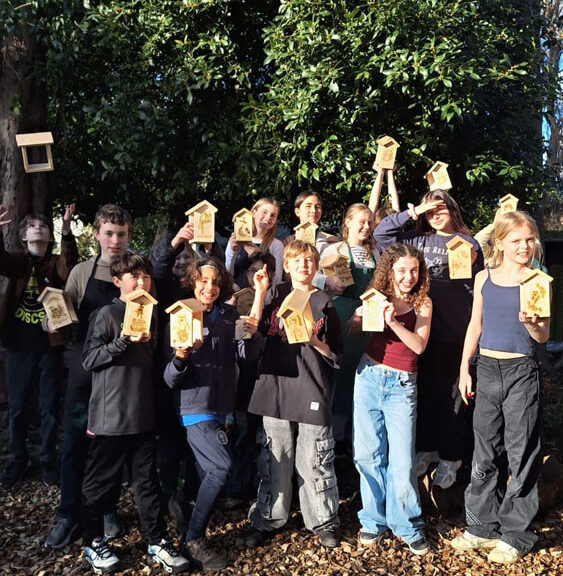 A group of students at The King Alfred School North London holding up bird feeders they have made in the Design Technology department